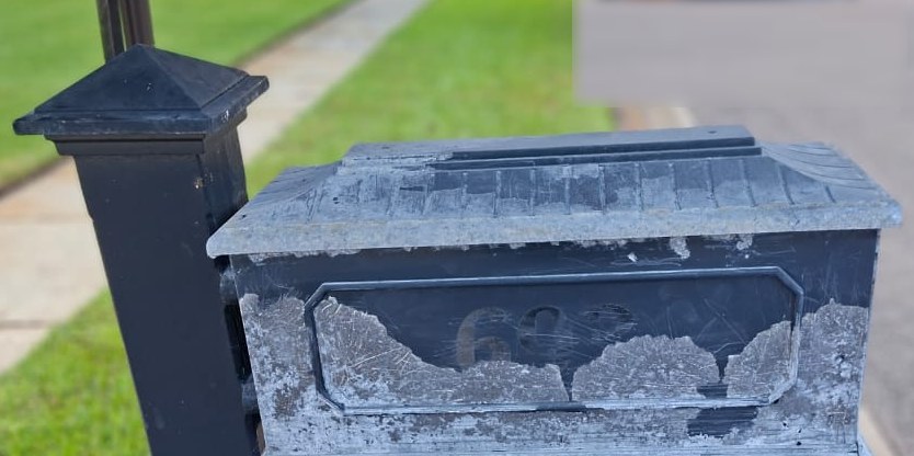 Corroded, oxidized cast-aluminum mailbox before restoration